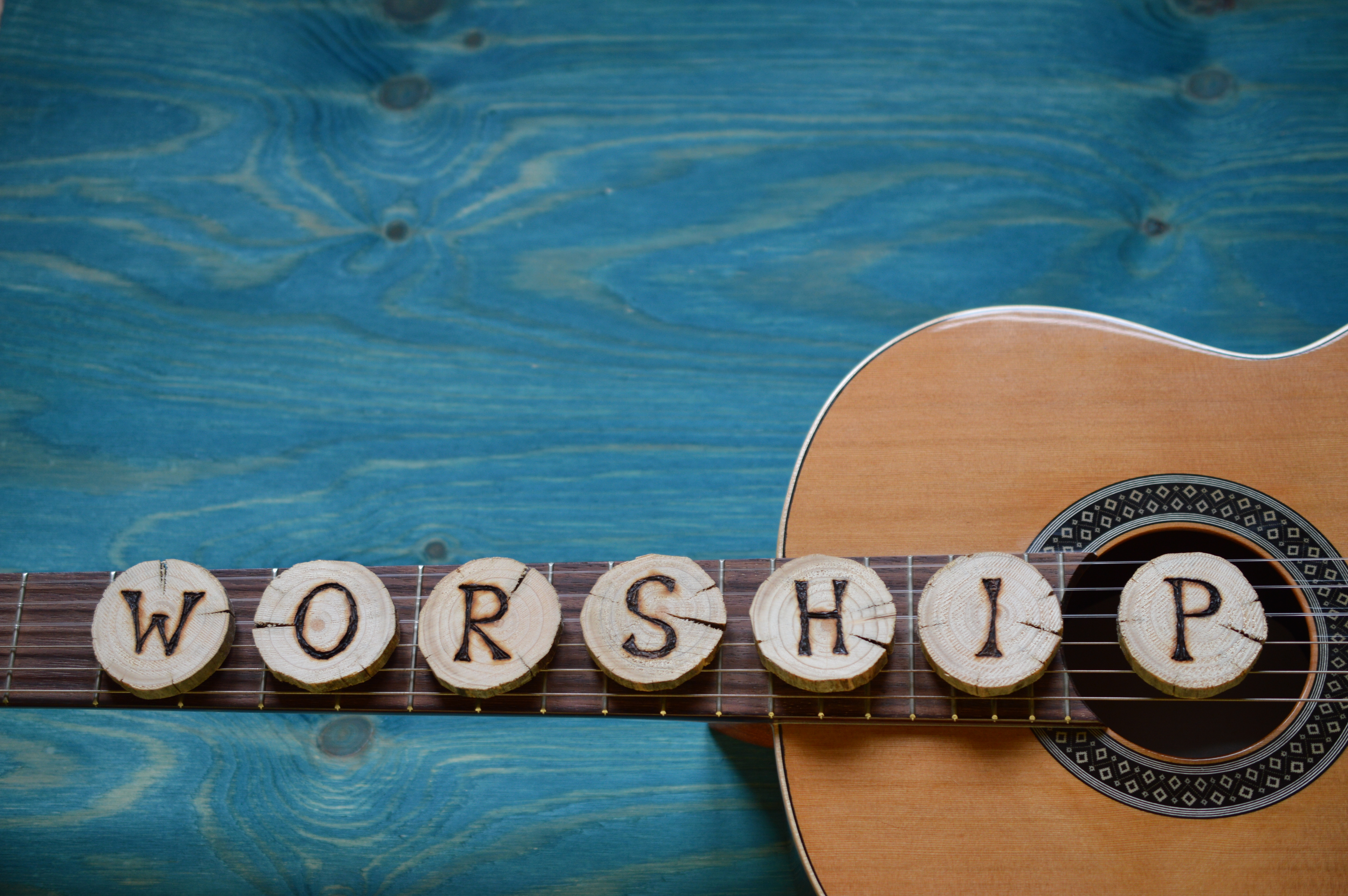 a guitar with the words worship spelled out on it